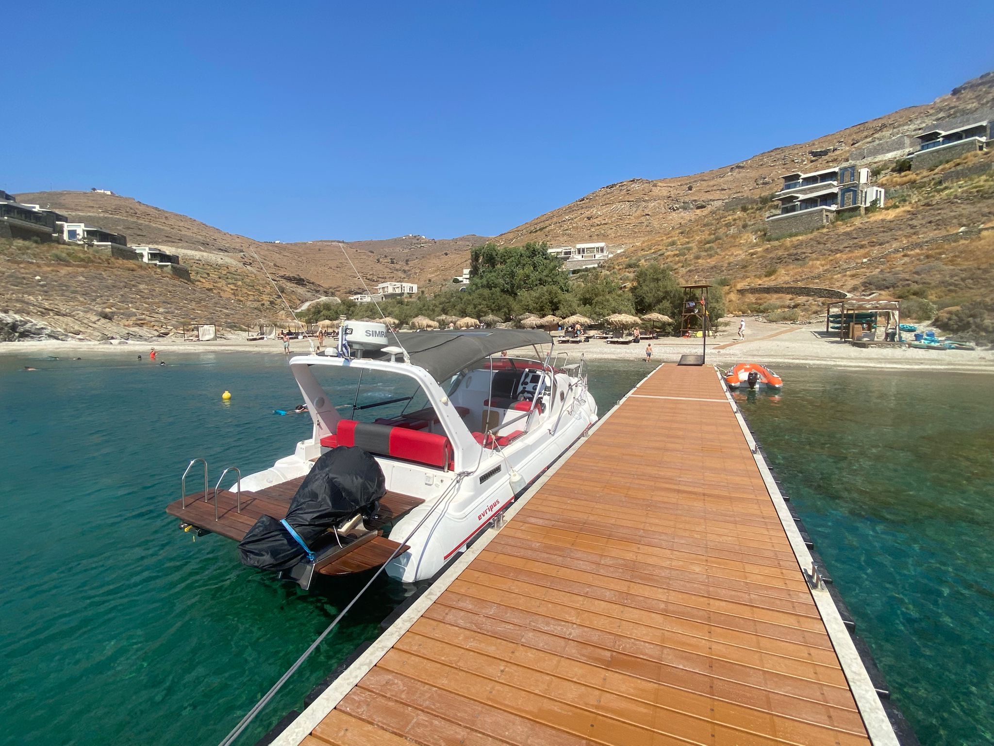 Zen Explorer moored to a pier in front of the beach
