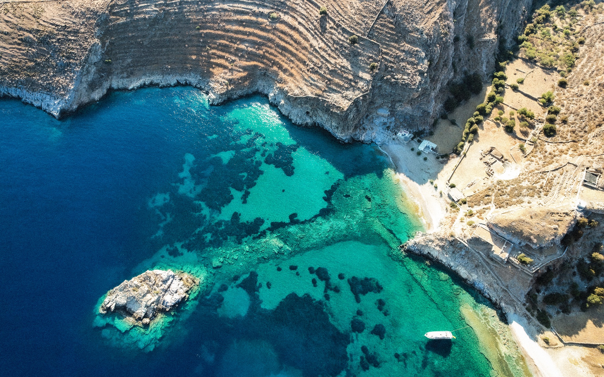 Aerial view of the rocky coast and turquoise sea of Kea