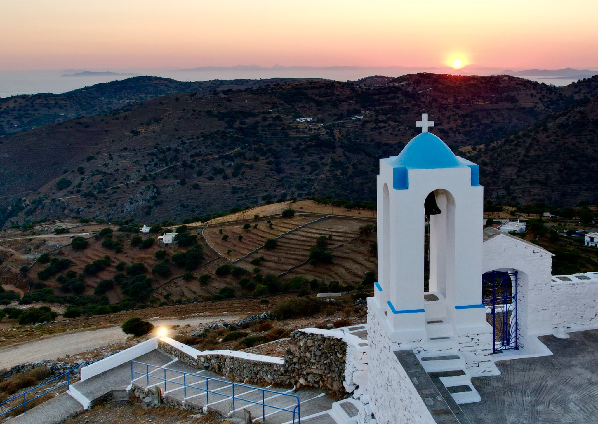 Sunset over a blue and white church in Kea